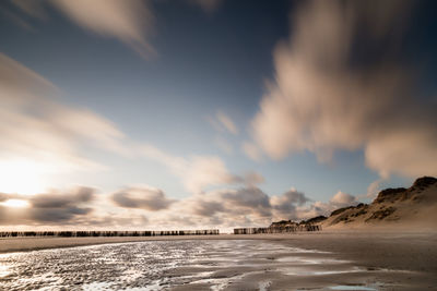 Scenic view of beach against sky during sunset