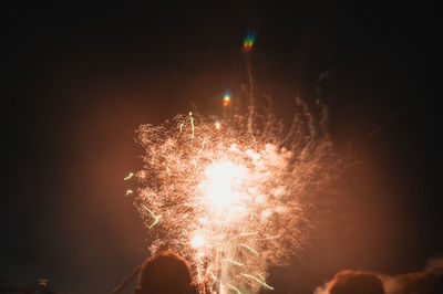 Low angle view of firework display at night