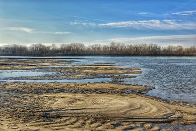 Scenic view of lake against sky during winter