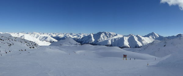 Scenic view of snowcapped mountains against sky