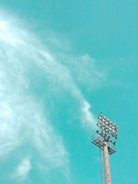 Low angle view of communications tower against blue sky