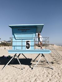 Man standing on beach against clear sky