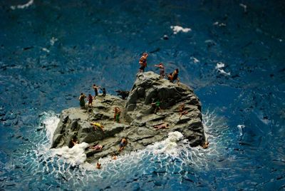 High angle view of figurines on rock sculpture