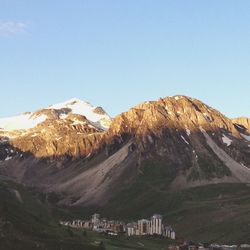 Scenic view of mountains against clear blue sky