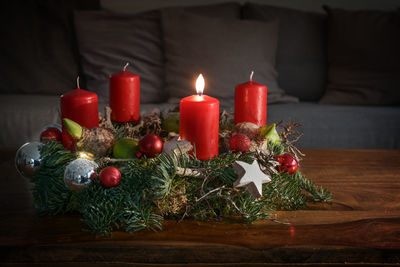 Close-up of illuminated candles on table