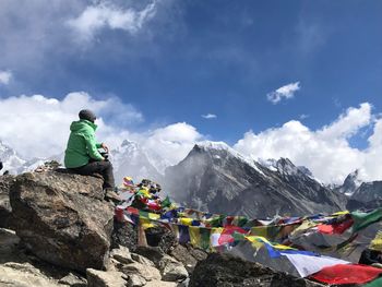 Panoramic view of people on rock against sky