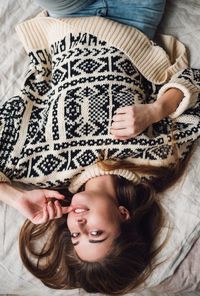 High angle view of baby girl lying on bed at home