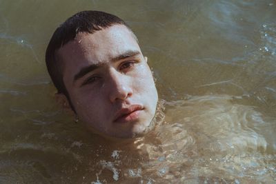 High angle portrait of man swimming in pool