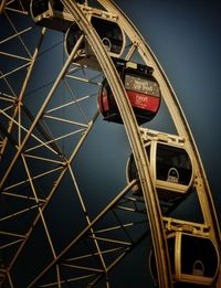 Low angle view of ferris wheel against sky