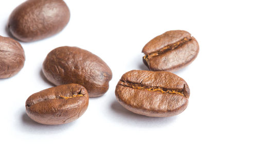 Close-up of coffee beans against white background