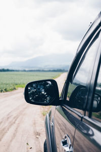 Close-up of car on road against sky