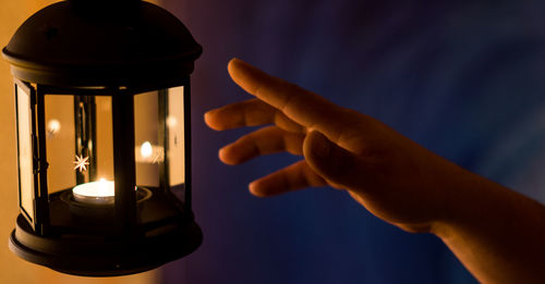 Cropped hand reaching lantern