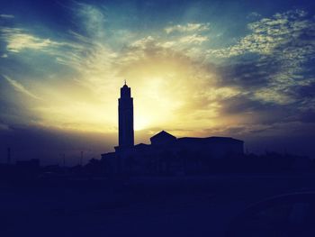 Silhouette of built structure at sunset