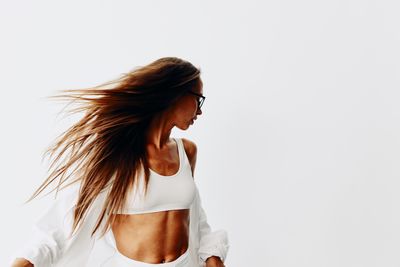 Young woman standing against white background