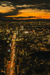 High angle view of illuminated cityscape against sky at night