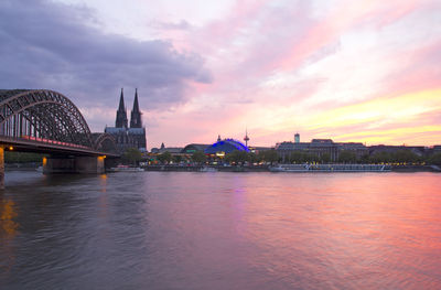 View of bridge over river against cloudy sky