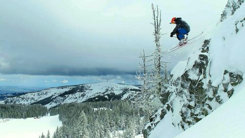 Low angle view of man skiing on snow landscape