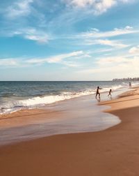 Boys playing on shore at beach