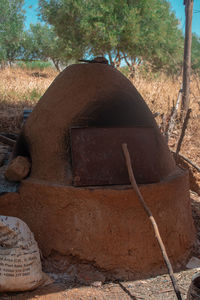 Close-up of old rusty wheel on field