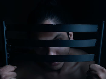 Cropped image of woman standing on railing