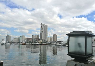 Low angle view of skyscrapers against cloudy sky