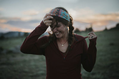 Portrait of smiling young woman standing outdoors