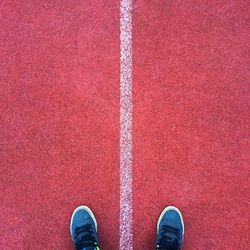 Low section of person standing on running track