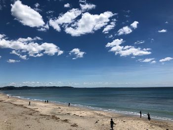 Scenic view of beach against blue sky