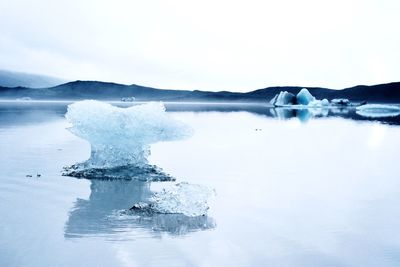 Scenic view of frozen lake against sky