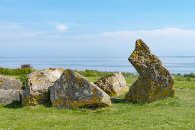 Rocks by sea against sky