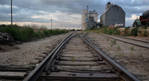 View of railroad tracks against cloudy sky