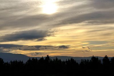 Scenic view of silhouette mountains against sky at sunset