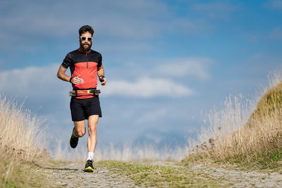 Full length of man running on road