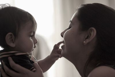 Close-up of mother with baby at home