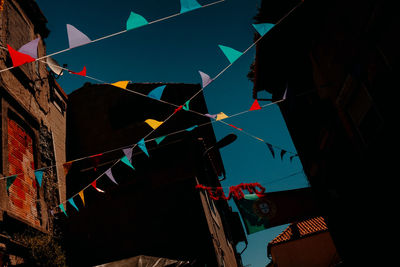 Low angle view of flags hanging against buildings