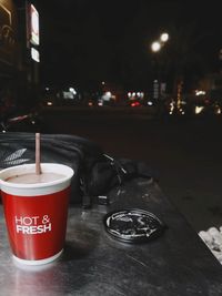 View of coffee on table in city at night