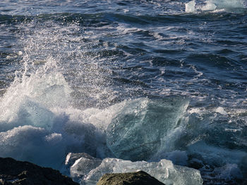 Waves splashing on rocks at shore