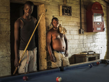 Full length of shirtless young man standing at home