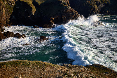 Scenic view of rocks and powerful tide on the coast