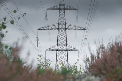 Low angle view of electricity pylon against sky