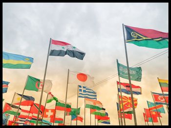 Low angle view of flag flags against sky