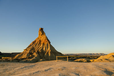 Scenic view of arid landscape against clear sky, bardenas reales, spain