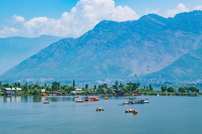 Scenic view of sea and mountains against sky