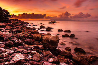 Scenic view of sea against romantic sky at sunset