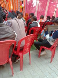 Group of people sitting on chair in city