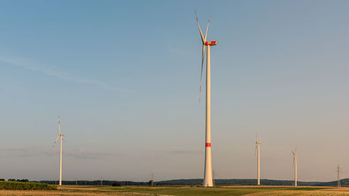 Wind turbines against sky