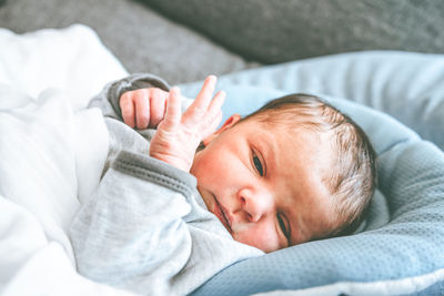 Cute baby lying on bed at home