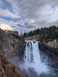 Scenic view of waterfall against sky