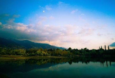 Scenic view of lake and mountains against sky