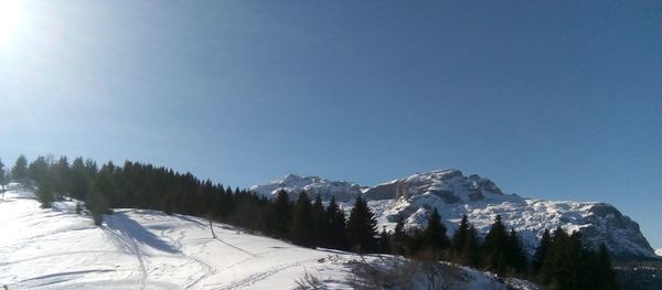 Scenic view of snowcapped mountains against clear sky